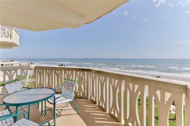 balcony featuring a water view and a view of the beach