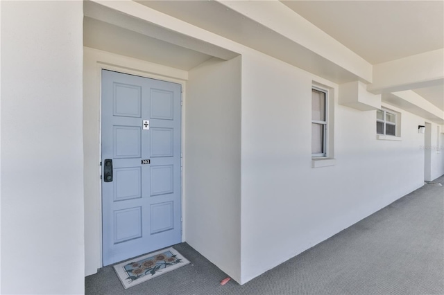 property entrance featuring stucco siding