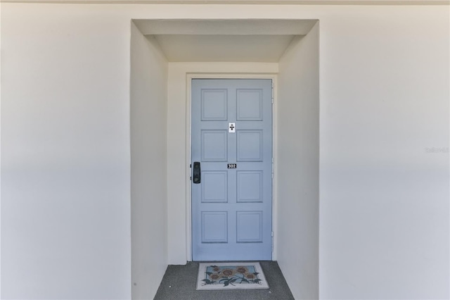 entrance to property featuring stucco siding