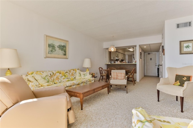 living area with carpet and visible vents