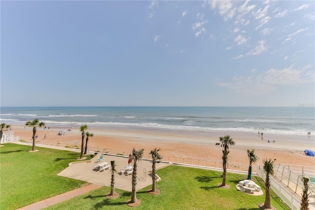 view of water feature with fence and a beach view