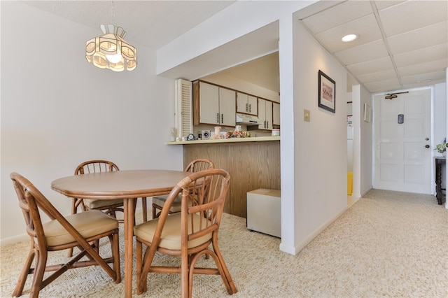 dining room featuring recessed lighting, baseboards, light carpet, and a drop ceiling