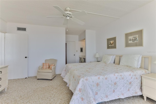 bedroom with carpet floors, ceiling fan, and visible vents