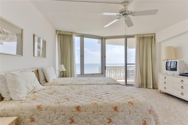 carpeted bedroom with access to exterior and ceiling fan