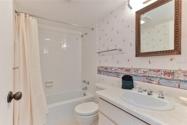 bathroom featuring shower / bathtub combination with curtain, toilet, and vanity