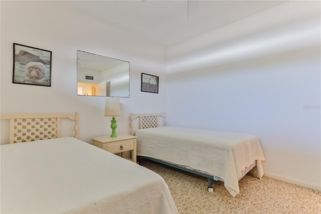 carpeted bedroom featuring baseboards and visible vents