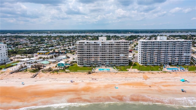 birds eye view of property with a view of city and a beach view