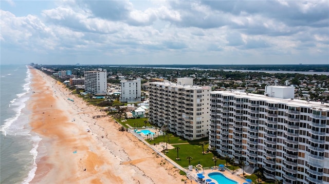 aerial view with a view of the beach, a water view, and a view of city