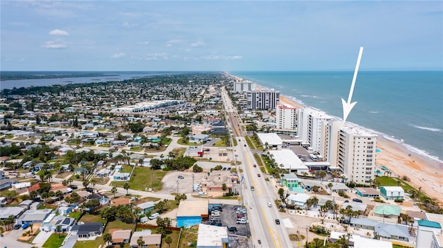 birds eye view of property featuring a water view, a beach view, and a city view