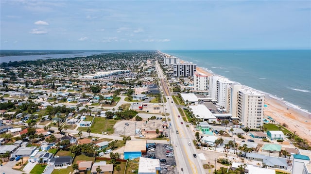 birds eye view of property featuring a view of city, a water view, and a beach view