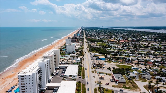 drone / aerial view with a water view and a beach view