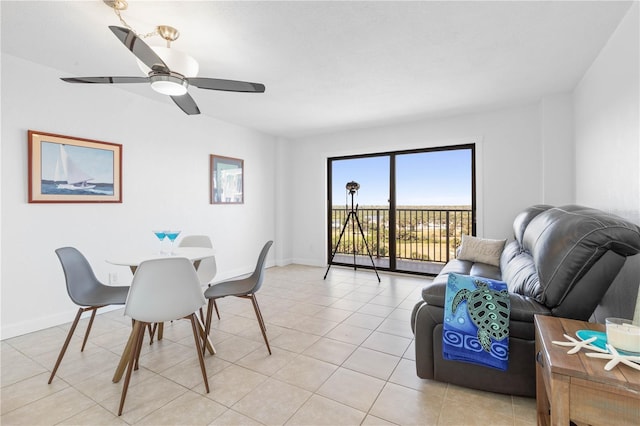 dining room featuring light tile patterned floors, ceiling fan, and baseboards