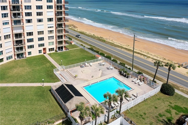 drone / aerial view featuring a water view and a view of the beach