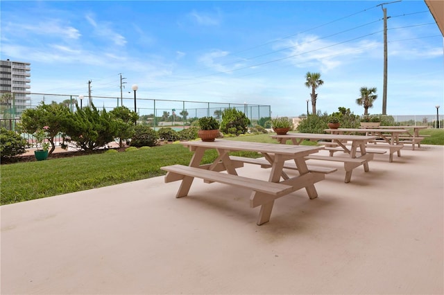 view of home's community featuring a yard, a patio area, and fence