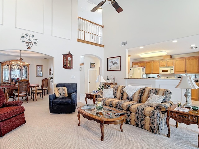 9 Cedar Hollow Ct, Palm Coast, FL 32137 - living room with arched walkways, visible vents, ceiling fan with notable chandelier, and light colored carpet