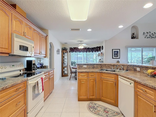 9 Cedar Hollow Ct, Palm Coast, FL 32137 - kitchen with white appliances, light tile patterned floors, a sink, arched walkways, and visible vents