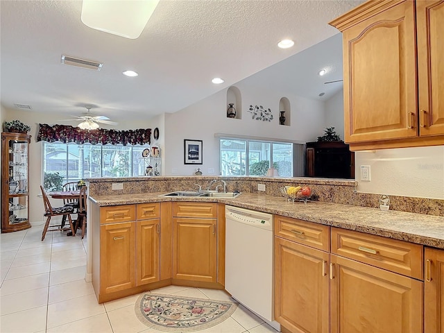 9 Cedar Hollow Ct, Palm Coast, FL 32137 - kitchen featuring vaulted ceiling, a sink, light tile patterned flooring, dishwasher, and a ceiling fan
