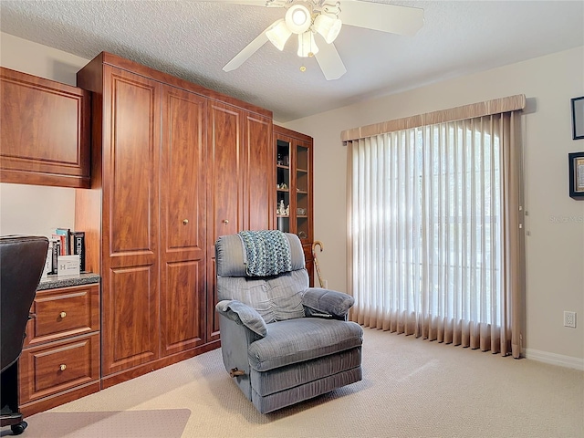 9 Cedar Hollow Ct, Palm Coast, FL 32137 - sitting room featuring light carpet, a textured ceiling, baseboards, and a ceiling fan
