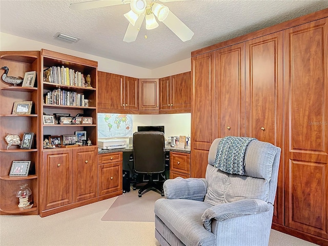 9 Cedar Hollow Ct, Palm Coast, FL 32137 - home office with built in study area, a textured ceiling, light colored carpet, visible vents, and ceiling fan