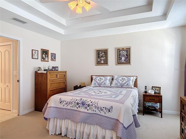 9 Cedar Hollow Ct, Palm Coast, FL 32137 - bedroom with baseboards, a tray ceiling, visible vents, and light colored carpet