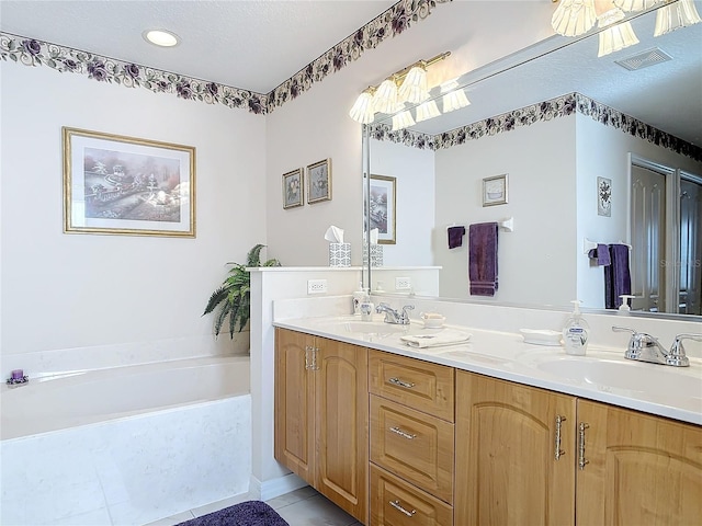 9 Cedar Hollow Ct, Palm Coast, FL 32137 - bathroom featuring a sink, double vanity, visible vents, and a bath