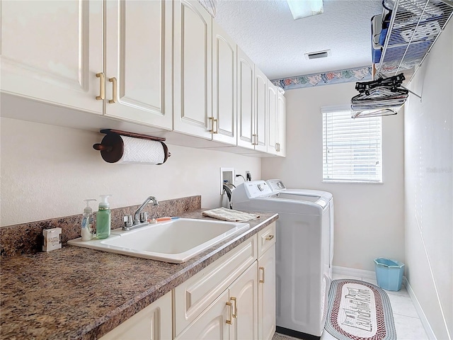 9 Cedar Hollow Ct, Palm Coast, FL 32137 - laundry room with a textured ceiling, a sink, visible vents, cabinet space, and washing machine and dryer