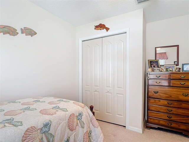 9 Cedar Hollow Ct, Palm Coast, FL 32137 - bedroom with a closet, baseboards, and light carpet