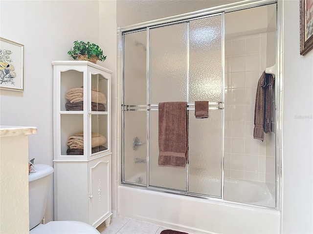 9 Cedar Hollow Ct, Palm Coast, FL 32137 - bathroom featuring tile patterned floors, bath / shower combo with glass door, and toilet