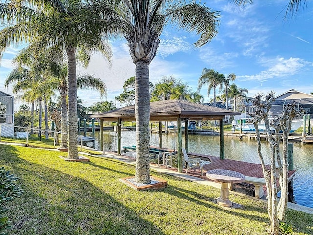 9 Cedar Hollow Ct, Palm Coast, FL 32137 - dock area featuring a water view, boat lift, and a yard