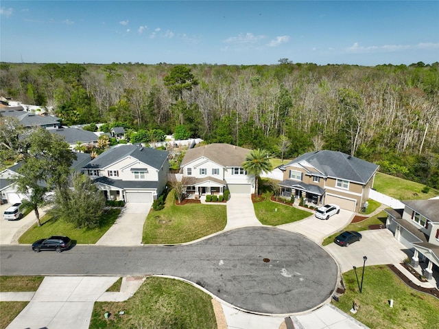 aerial view with a wooded view and a residential view