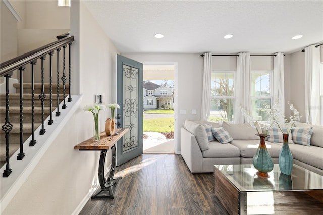 entrance foyer with baseboards, recessed lighting, dark wood-style flooring, stairs, and a textured ceiling