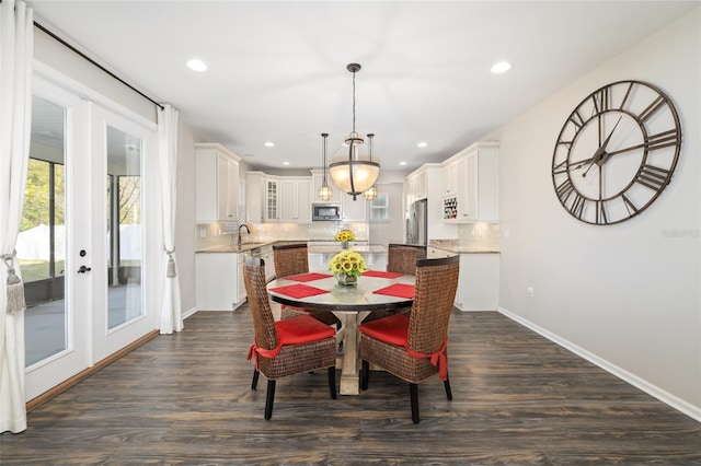 dining space featuring dark wood finished floors, recessed lighting, french doors, and baseboards