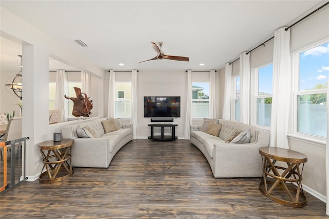 living room featuring visible vents, baseboards, ceiling fan, and wood finished floors