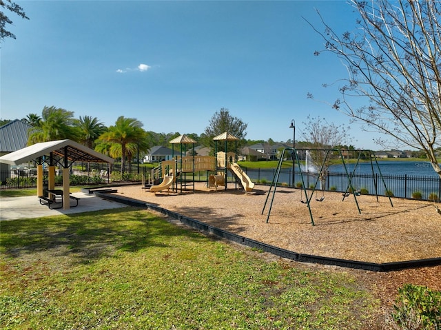 community play area with a yard and fence