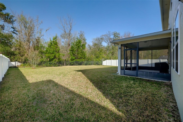 view of yard with a fenced backyard and a sunroom