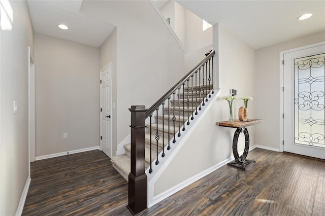 foyer with recessed lighting, stairs, baseboards, and wood finished floors