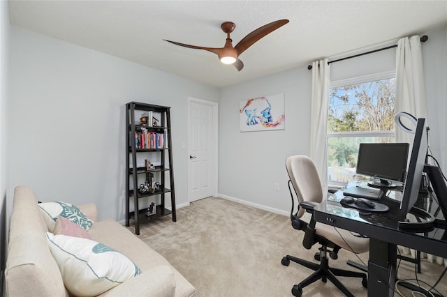 home office with light colored carpet, baseboards, and a ceiling fan