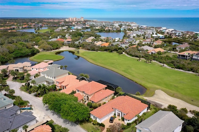 aerial view with a residential view, golf course view, and a water view