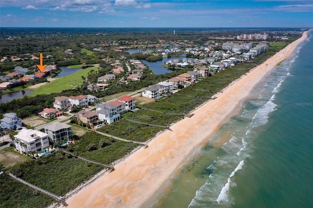aerial view with a water view and a beach view