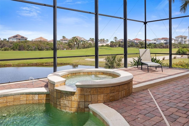 unfurnished sunroom with a water view and a jacuzzi