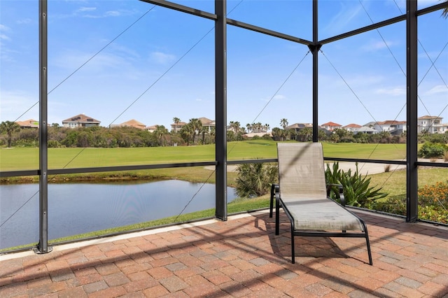 unfurnished sunroom with a water view
