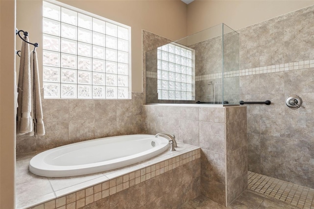 full bathroom featuring a bath and walk in shower