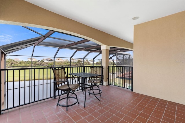 view of patio / terrace featuring glass enclosure