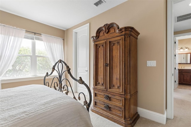 bedroom with baseboards, visible vents, and light carpet