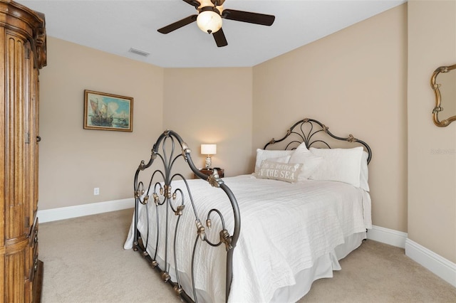 bedroom with light carpet, baseboards, visible vents, and a ceiling fan