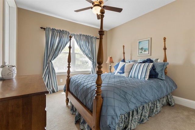 carpeted bedroom featuring baseboards and ceiling fan