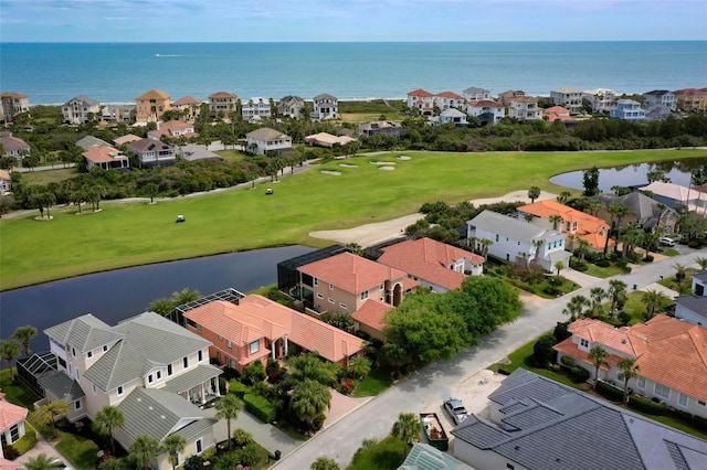 bird's eye view with a water view, view of golf course, and a residential view