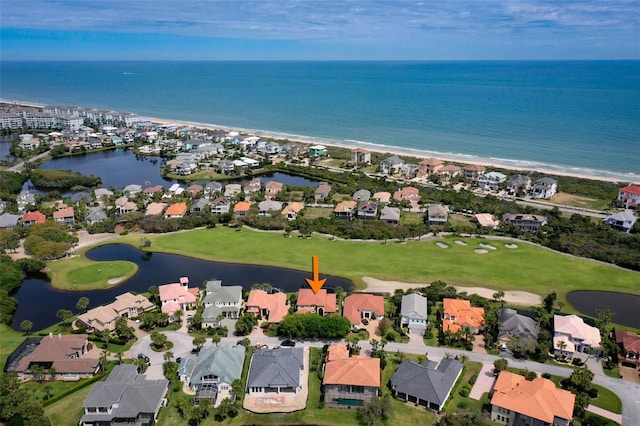 aerial view featuring a water view, view of golf course, and a residential view