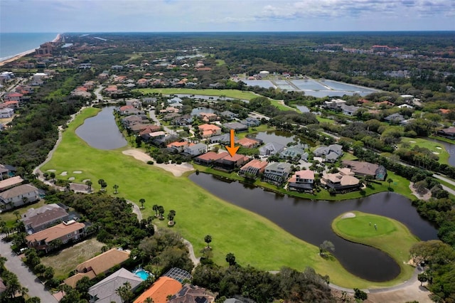 drone / aerial view featuring a water view, view of golf course, and a residential view