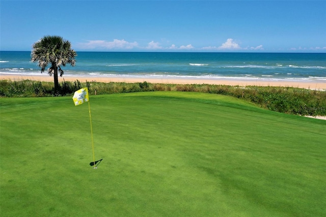 surrounding community with a water view and a view of the beach